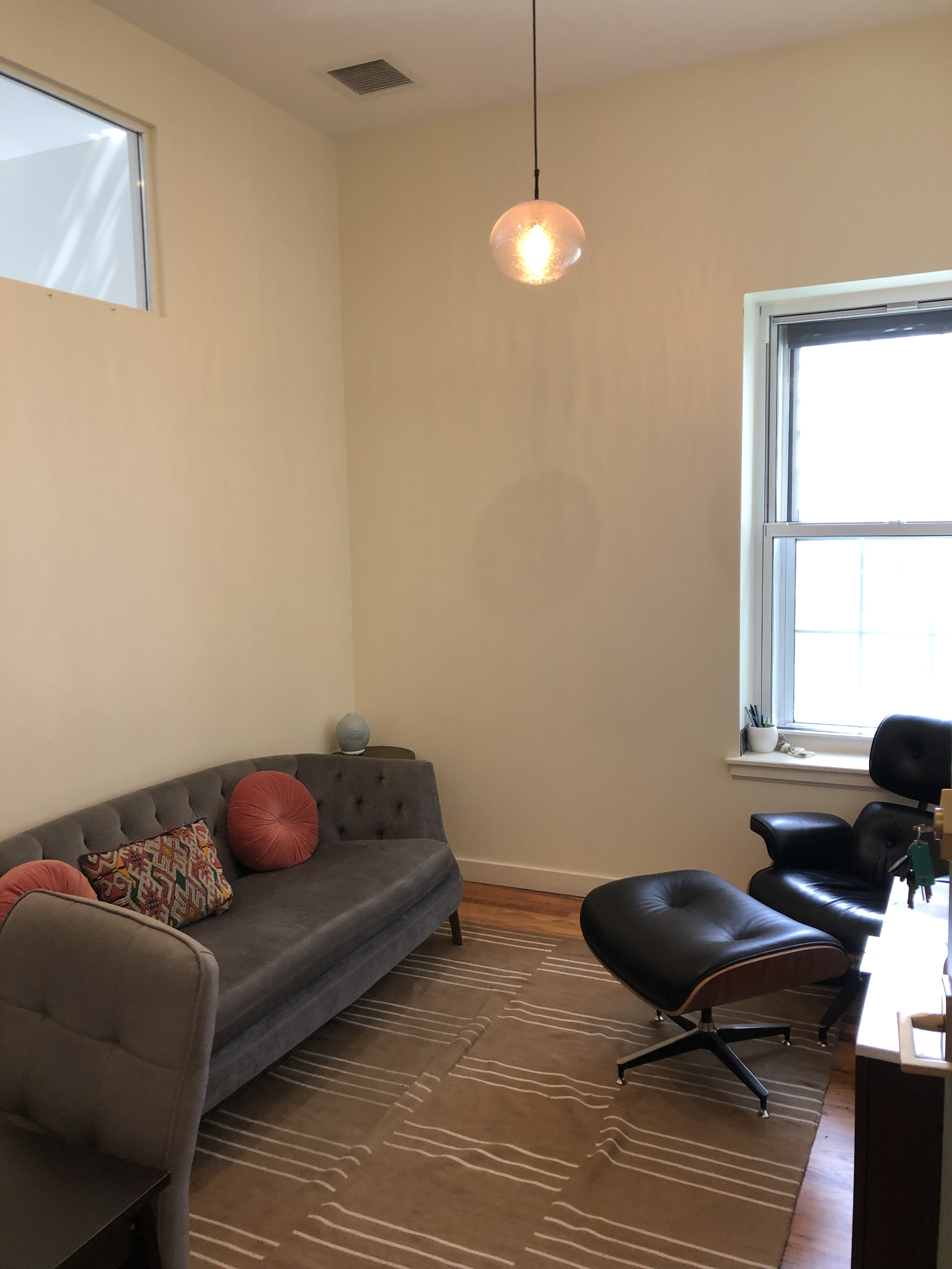 Comfortable living room area with couch and lamp